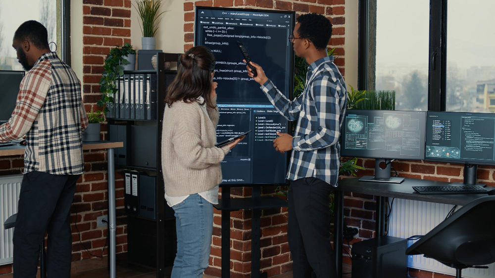 team-database-admins-analyzing-source-code-wall-screen-tv-comparing-errors-using-digital-tablet-busy-server-room-two-cloud-programers-debugging-algorithm-software-innovation-office